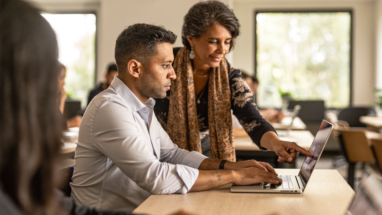 Mentor guiding a participant during a hands-on session